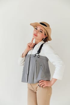 Portrait of a beautiful young woman in summer suit and hat