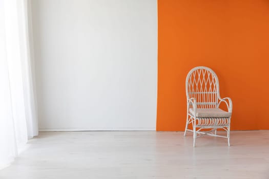 chair in the interior of an empty white and orange room