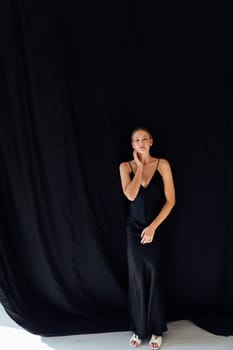 Portret of beautiful fashionable woman in black silk dress