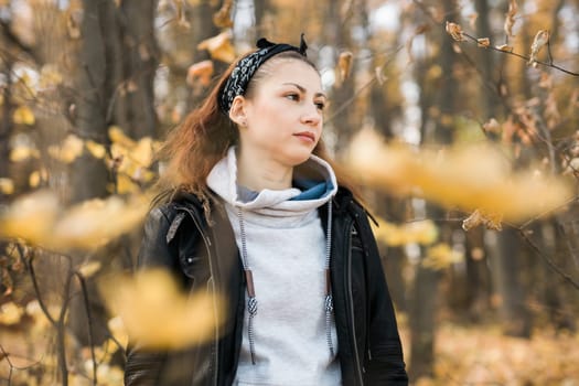 Outdoor atmospheric lifestyle portrait of young beautiful young woman copy space. Warm autumn fall season. Millennial generation and youth.