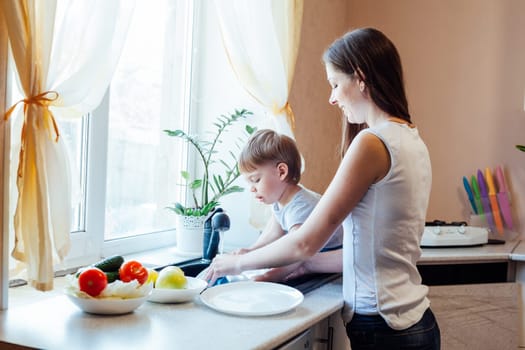 mom cleans the vegetables in the kitchen boy it interferes