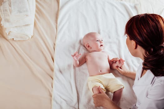 the little boy baby mother doing massage hands and legs 1