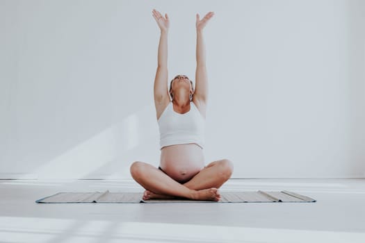 a pregnant woman is engaged in gymnastics and yoga childbirth