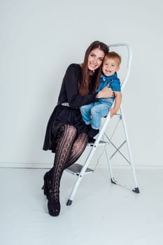 mother and young son on the stairs stepladder 1