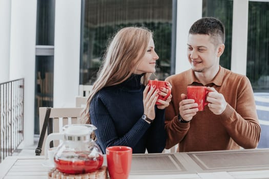 restaurant on the street. a guy with a girl drink hot coffee and tea