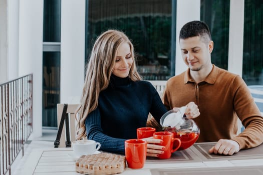 husband with wife on holiday drink hot coffee and tea 1