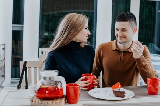 husband with wife on holiday drink hot coffee and tea 1