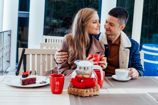 restaurant on the street. a guy with a girl drink hot coffee and tea 1