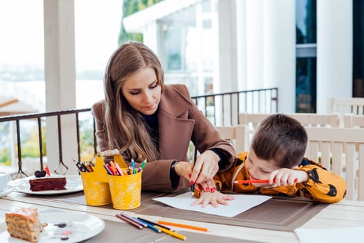 mother and son draw drawing hands colored pencils 1