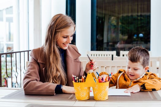 mom and young boy draw colored pencils 1