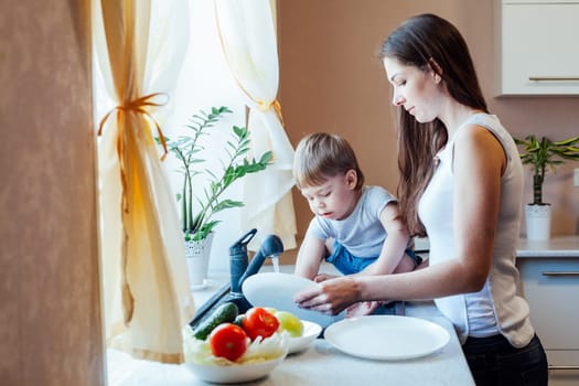 mom teaches boy wash products in the sink