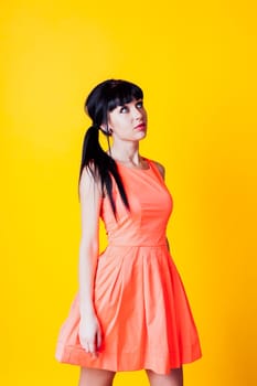 girl in orange dress on a yellow background 1