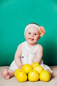 baby girl in a dress with Green apples 1