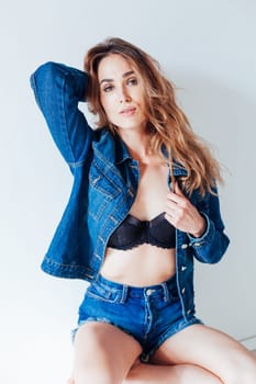 portrait of a beautiful woman in lingerie and denim shorts