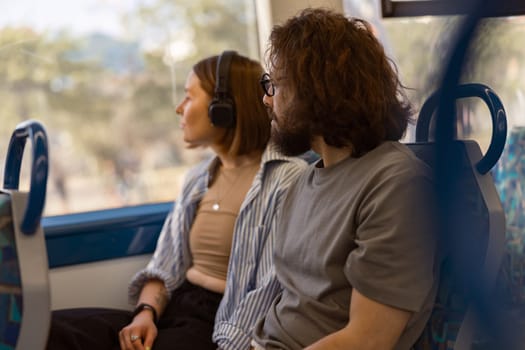 Young romantic couple is travel together while riding in public bus . High quality photo