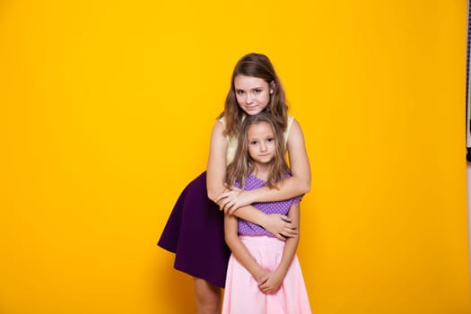 Portrait of two beautiful girls in dresses