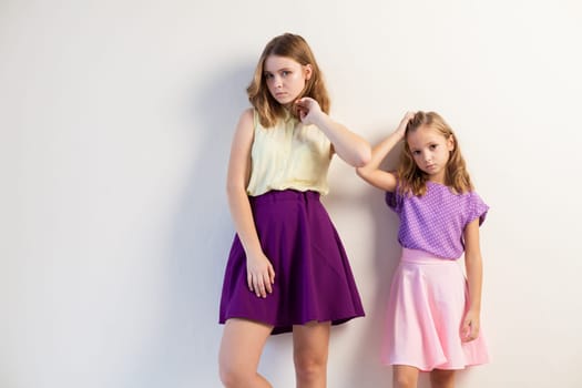 Portrait of two beautiful girls in dresses