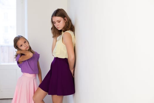 Portrait of two beautiful girls in dresses