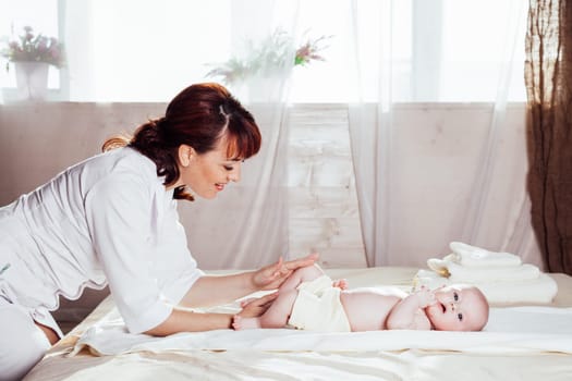 the little boy baby doctor doing massage hands and legs