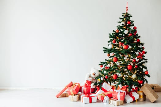 Christmas tree with gifts of red decor for the new year winter