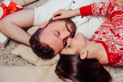 the guy with the girl lying on the floor at the new year Christmas tree 1