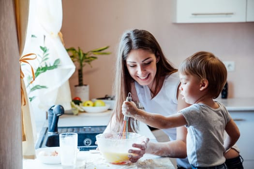 mother and young son prepare pie in the kitchen 1