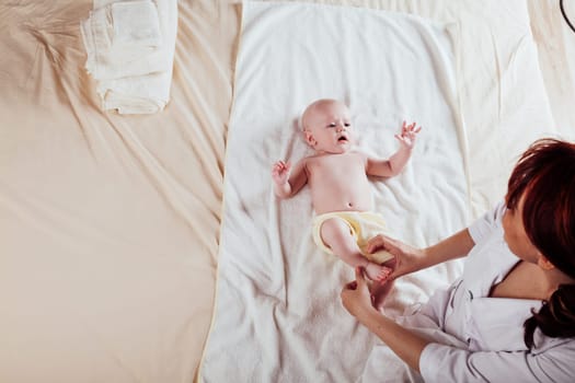 the little boy baby mother doing massage hands and legs 1