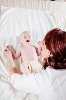 the little boy baby mother doing massage hands and legs 1