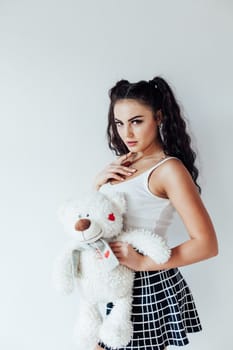 Portrait of a beautiful woman with a soft polar bear toy