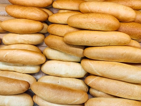 lots of fresh bread on the table as a background