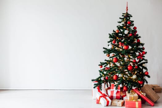 Christmas tree with red gifts decor white interior