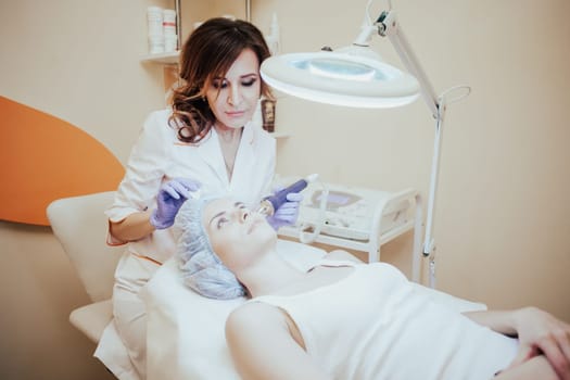 Cosmetology doctor makes the procedure a woman face cleaning 1