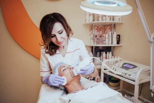 Cosmetology doctor makes the procedure a woman face cleaning 1