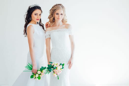 two brides in white wedding flowers