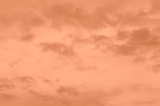 Peach Fuzz toned sky and clouds. Monochrome background 2024 color of the year. High quality photo