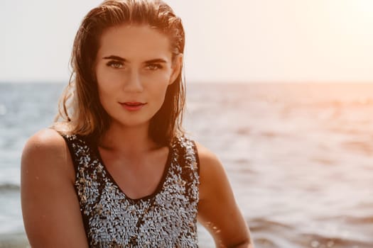 Woman travel sea. Young Happy woman in a long red dress posing on a beach near the sea on background of volcanic rocks, like in Iceland, sharing travel adventure journey