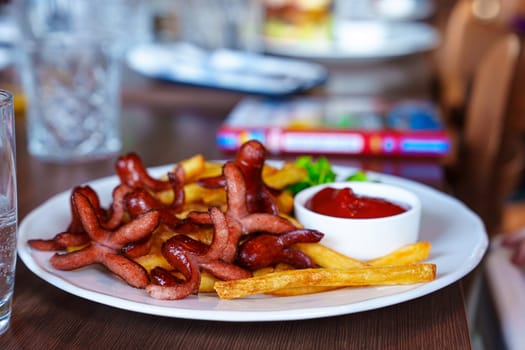 A mouth-watering children's menu featuring savory sausages, crispy French fries, and vibrant ketchup served on a pristine white plate in the inviting ambiance of a restaurant.