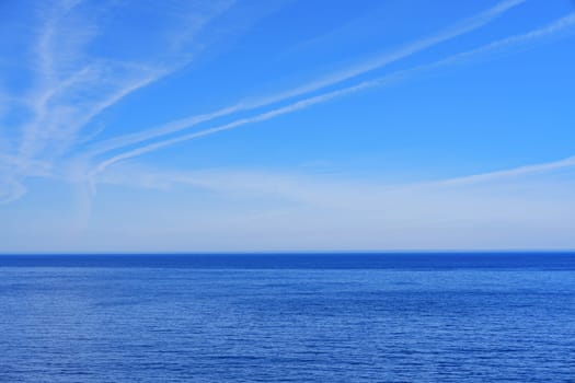 Tranquil seascape with a clear blue sky stretching to the horizon, perfect for promotional advertisements and travel brochures. The serene scene evokes a sense of peace and relaxation.