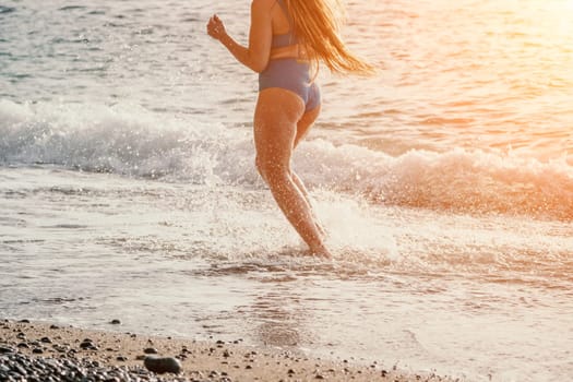 Running woman. Female runner jogging during the sunrise on beach. Woman Runner feet running on the beach at sunrise. woman fitness sunrise jog workout wellness concept.