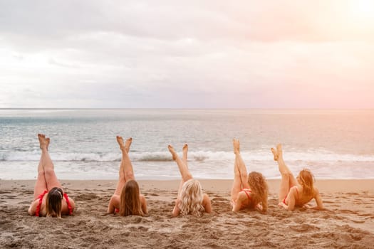 Big happy family or group of five friends is having fun against sunset beach. Beach holidays concept