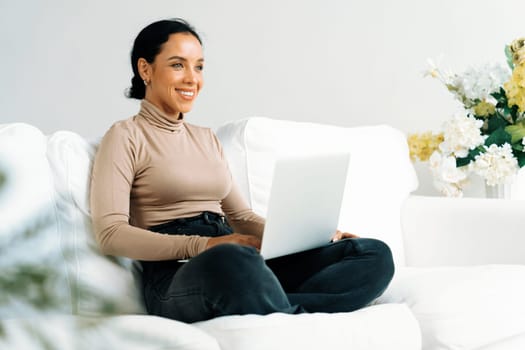 African-American woman using laptop computer for crucial work on internet. Secretary or online content writing working at home.