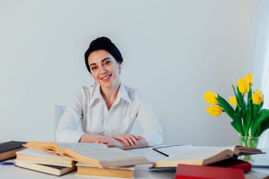 a woman in a business suit reads books in the Office 1