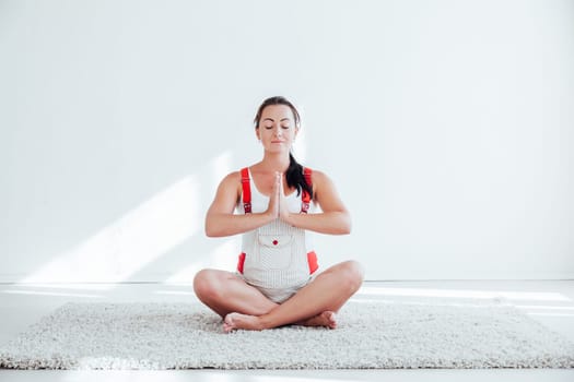 a pregnant woman is engaged in gymnastics and yoga before childbirth