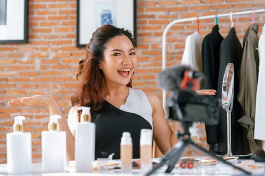 Woman influencer shoot live streaming vlog video review makeup uttermost social media or blog. Happy young girl with cosmetics studio lighting for marketing recording session broadcasting online.