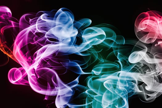 Abstract colorful smoke on black background.