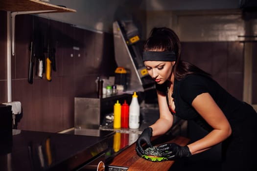 beautiful girl Cook prepares the kitchen Burger 1