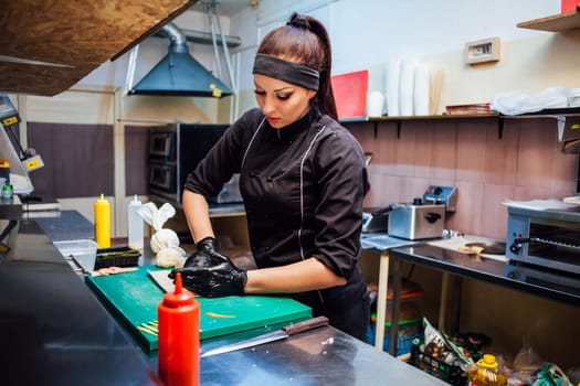 the Cook woman prepares food sushi restaurant kitchen 1