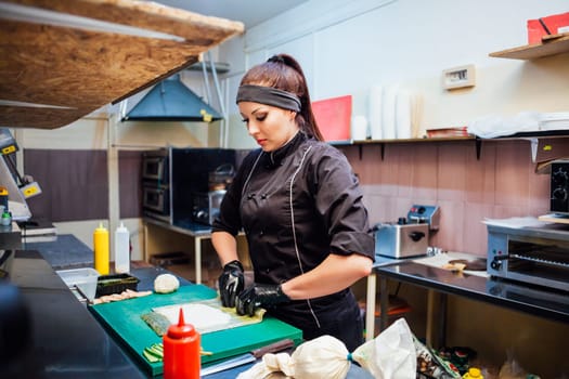 the Cook woman prepares food sushi restaurant kitchen 1