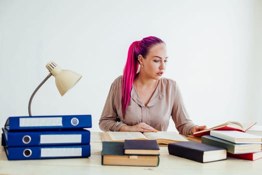 business girl sits in the Office for books folders of paper Secretary