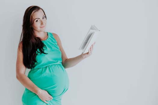 pregnant woman reading a book before childbirth 1